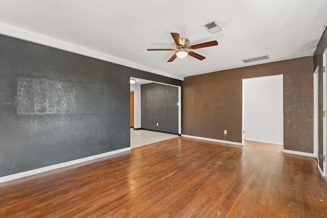 empty room featuring hardwood / wood-style flooring and ceiling fan