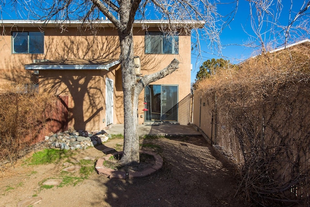 view of side of property with a patio area