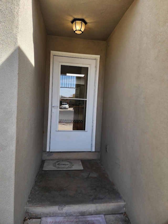 7535 Quemado Ct NE, Albuquerque, NM 87109 - doorway to property with stucco siding
