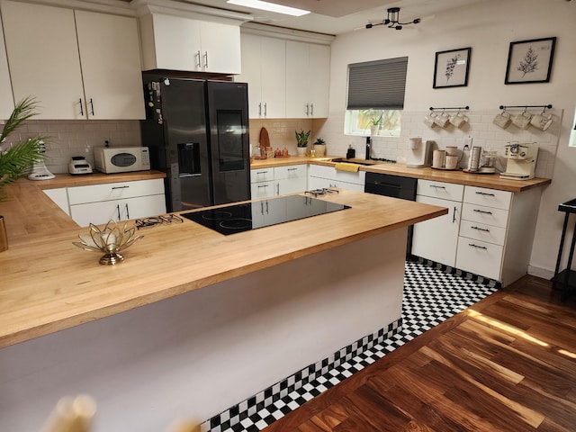 7535 Quemado Ct NE, Albuquerque, NM 87109 - kitchen featuring black electric cooktop, butcher block counters, a sink, white cabinetry, and fridge with ice dispenser