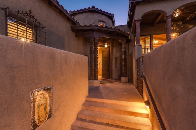 view of exterior entry at dusk