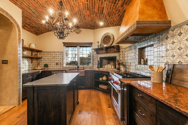 kitchen featuring a kitchen island, brick ceiling, high end range, custom exhaust hood, and light hardwood / wood-style flooring