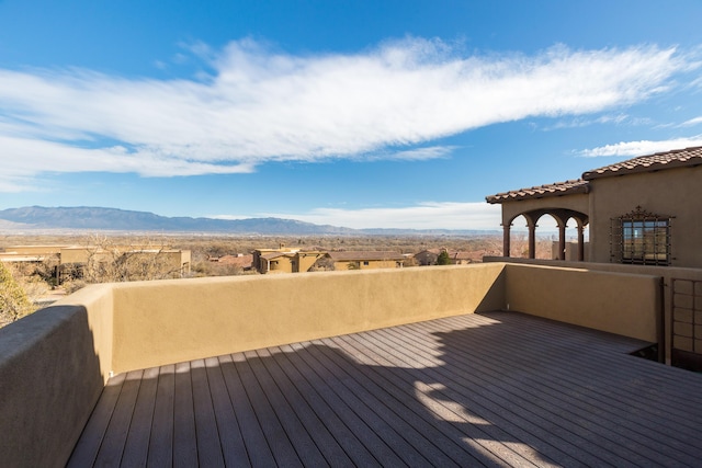 wooden deck with a mountain view