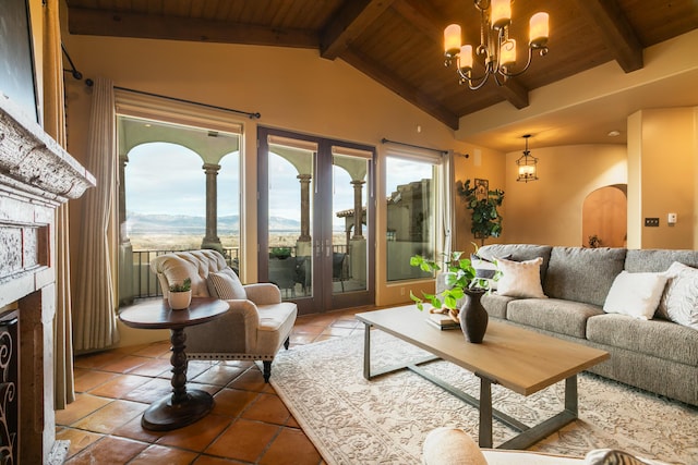 sunroom with an inviting chandelier, vaulted ceiling with beams, a mountain view, and wooden ceiling