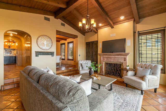 tiled living room with an inviting chandelier, a premium fireplace, and wooden ceiling