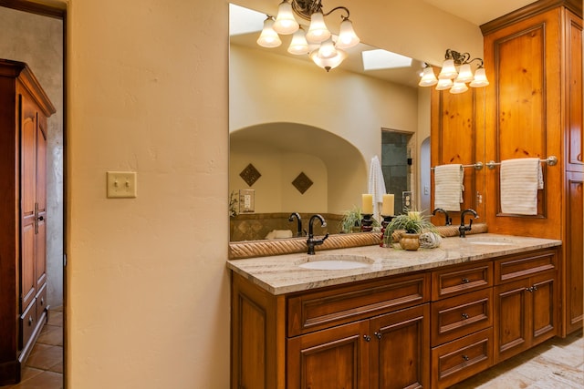 bathroom featuring vanity, tile patterned flooring, and a notable chandelier