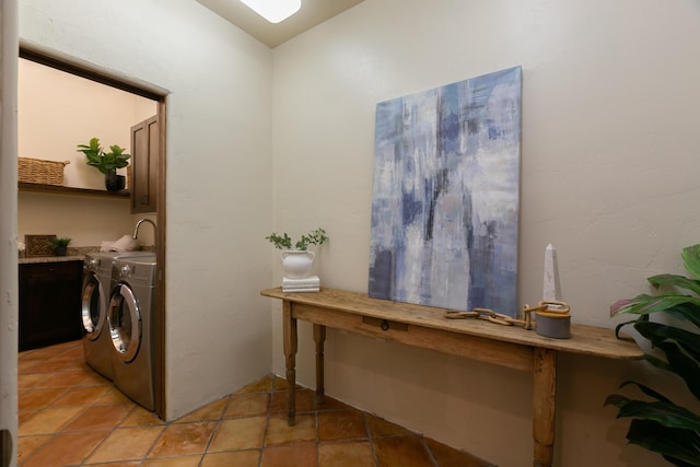 washroom with light tile patterned floors and washer and clothes dryer