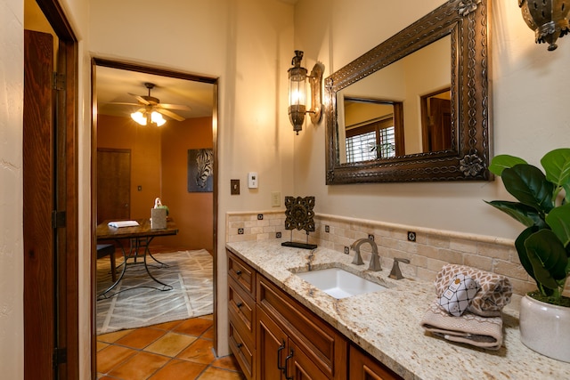 bathroom with tasteful backsplash, vanity, tile patterned floors, and ceiling fan