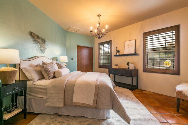 bedroom featuring a chandelier and tile patterned flooring