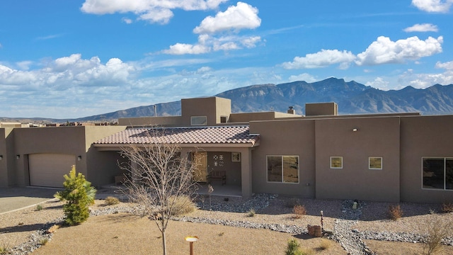 view of front of property with a garage and a mountain view