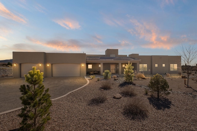 southwest-style home with a garage