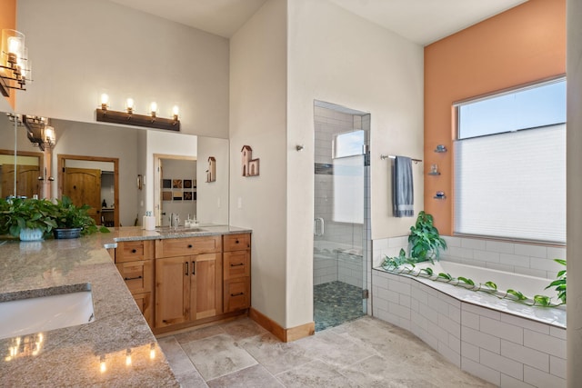 bathroom with vanity and independent shower and bath