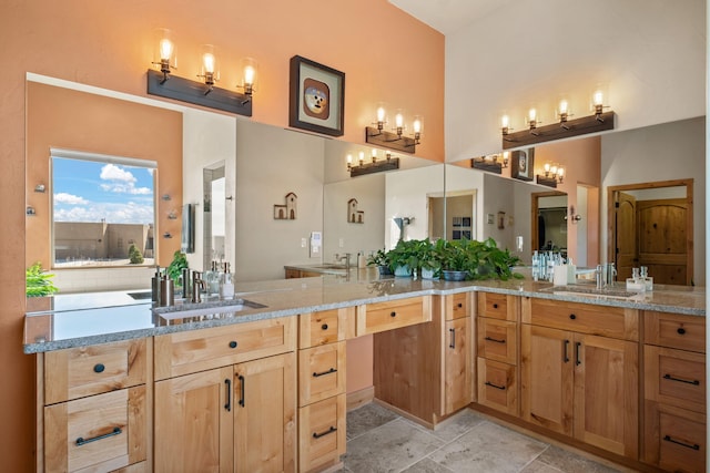 bathroom featuring vanity and a high ceiling