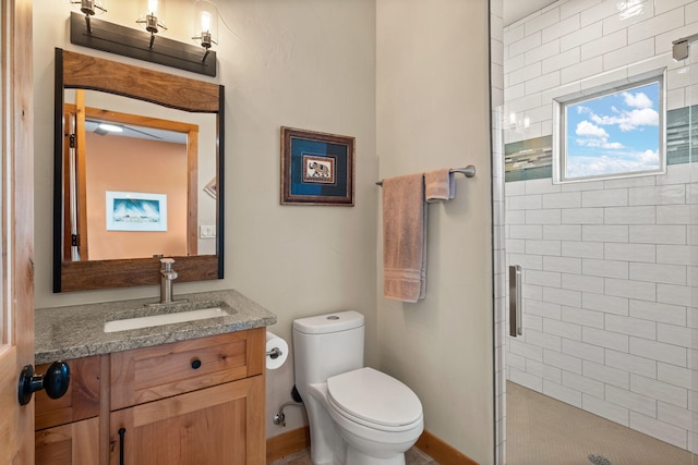 bathroom featuring vanity, an enclosed shower, and toilet