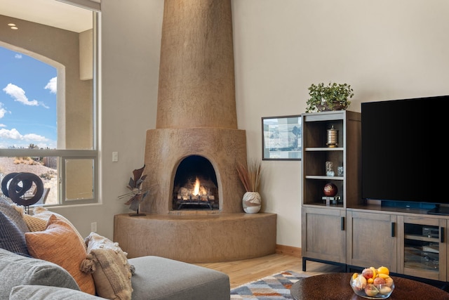 living room with light hardwood / wood-style flooring and a high end fireplace