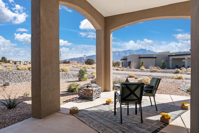 view of patio featuring a mountain view and a fire pit