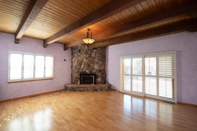 unfurnished living room with baseboards, wood ceiling, light wood-style floors, a fireplace, and beam ceiling