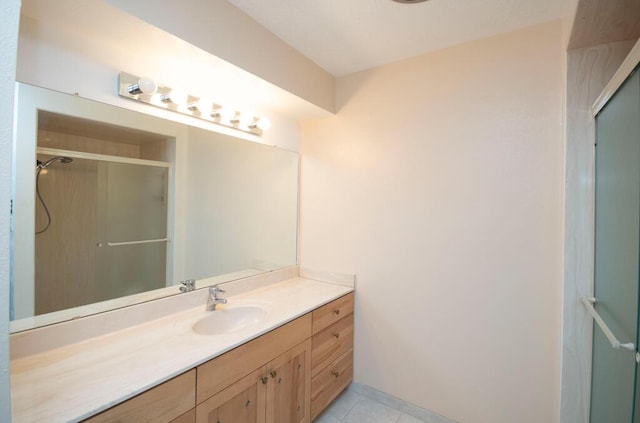 full bathroom featuring vanity, a shower stall, and tile patterned floors