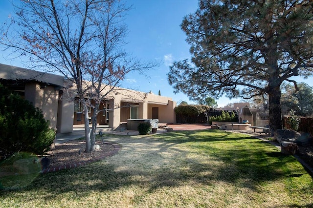 view of yard with a fenced backyard, a jacuzzi, and a patio