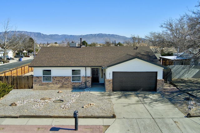 ranch-style house with a garage and a mountain view