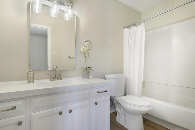 full bathroom with shower / bath combo, hardwood / wood-style floors, vanity, and toilet