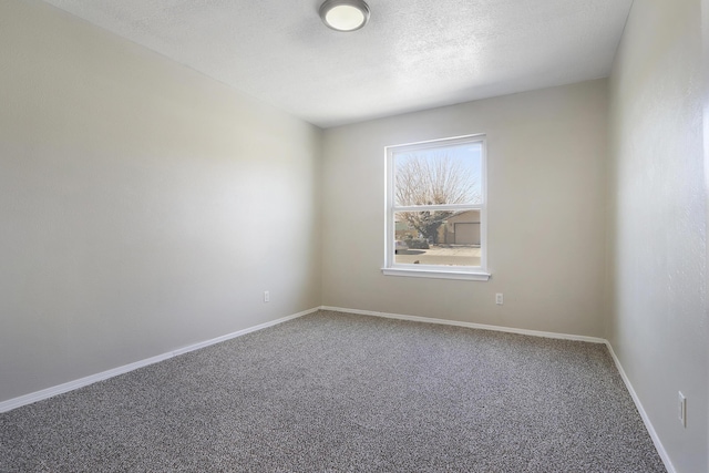 empty room featuring carpet floors and a textured ceiling