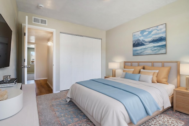 bedroom featuring hardwood / wood-style floors and a closet