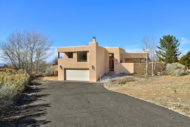 adobe home featuring a garage