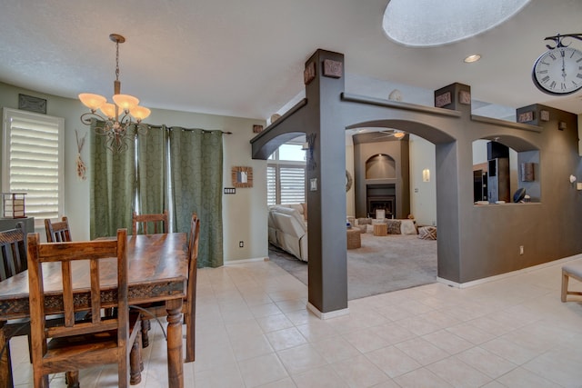 tiled dining area featuring a chandelier