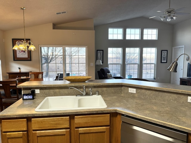 kitchen with vaulted ceiling, stainless steel dishwasher, plenty of natural light, and sink