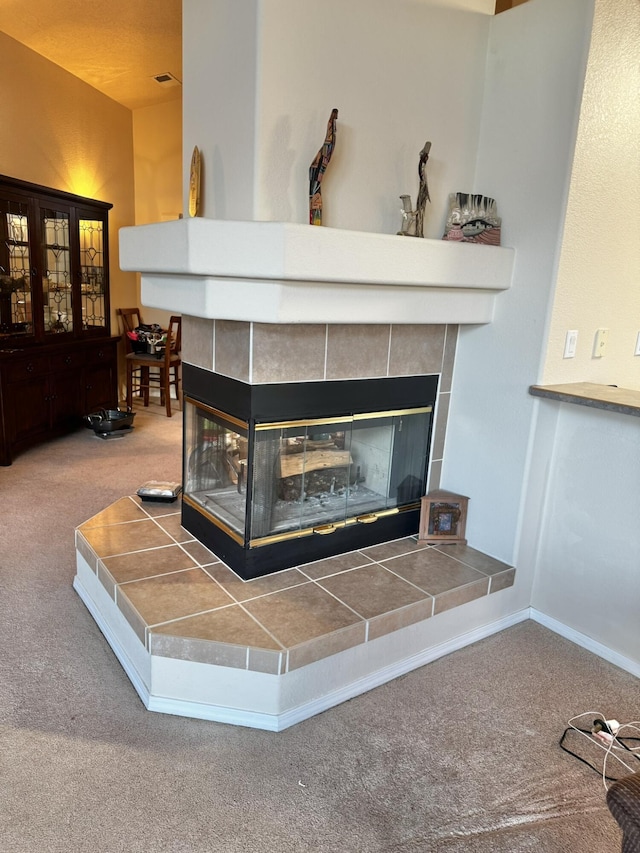 room details featuring a fireplace and carpet