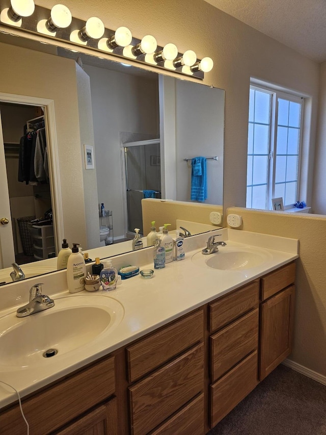 bathroom featuring vanity and a shower with shower door