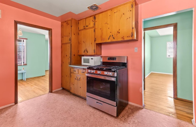 kitchen featuring light wood-type flooring and stainless steel gas stove