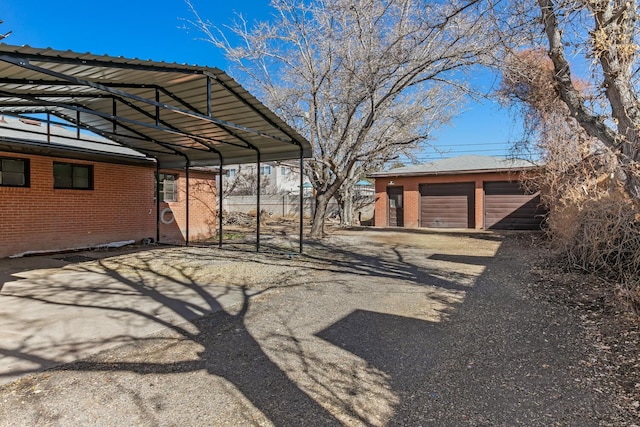 view of vehicle parking with a garage and a carport