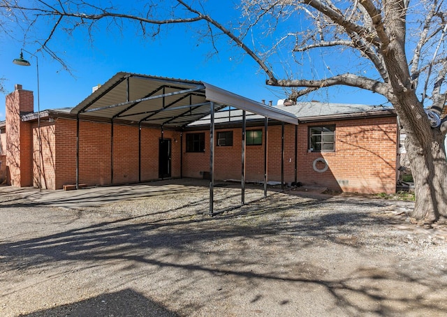 back of house with a carport