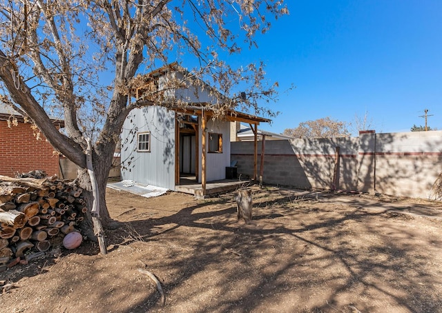 back of house with an outdoor structure