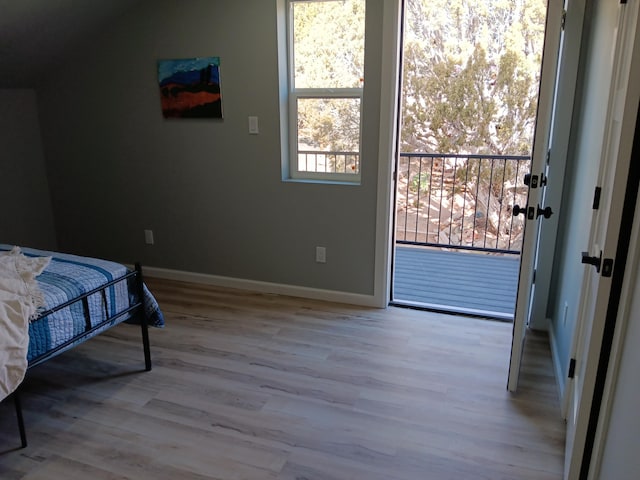 bedroom with access to outside and light hardwood / wood-style floors