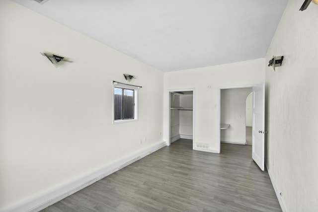 unfurnished bedroom with wood-type flooring and a closet