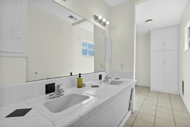 bathroom with tile patterned flooring and vanity