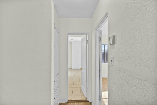 hallway with light hardwood / wood-style flooring