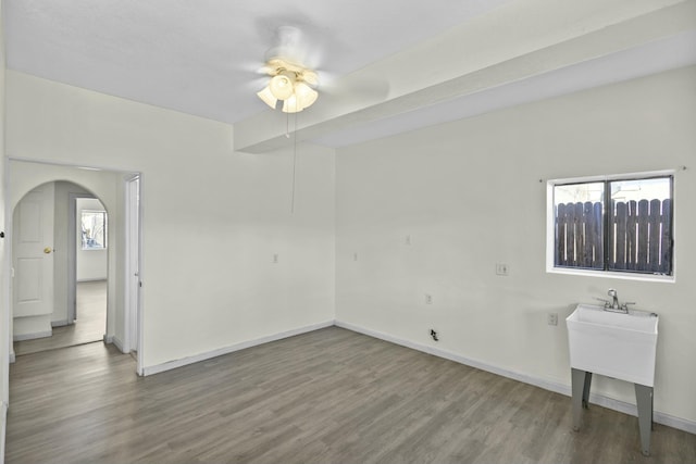 spare room with plenty of natural light, hardwood / wood-style floors, and ceiling fan