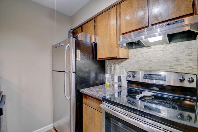 kitchen featuring stainless steel appliances and tasteful backsplash