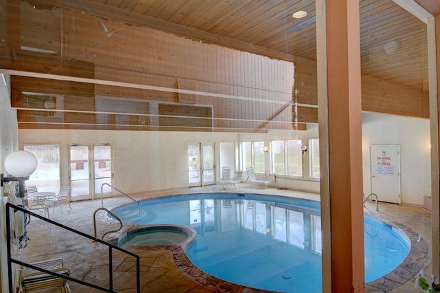 view of swimming pool featuring an indoor hot tub