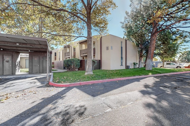 view of property exterior featuring a carport and a yard