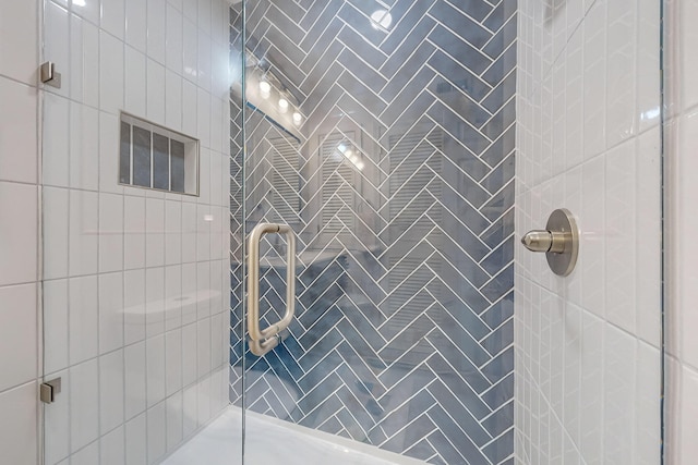 bathroom with a shower with shower door