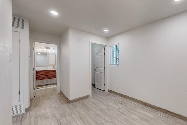 unfurnished room with light wood-type flooring