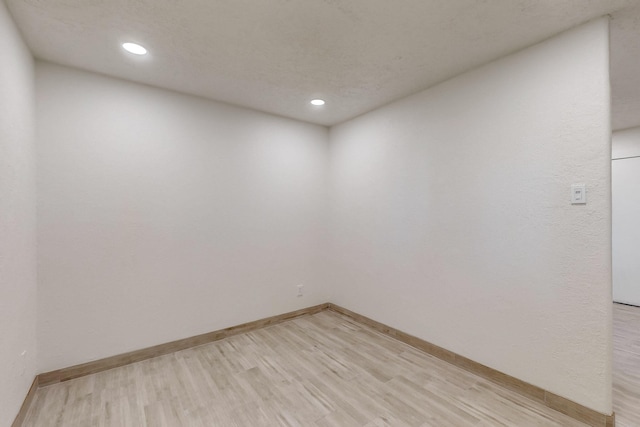 empty room with light hardwood / wood-style flooring