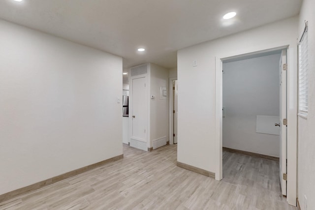 unfurnished room with light hardwood / wood-style floors