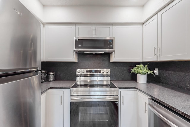 kitchen with tasteful backsplash, stainless steel appliances, and white cabinets