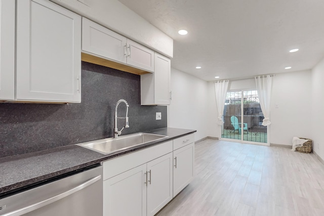 kitchen featuring white cabinetry, dishwasher, sink, and light wood-type flooring